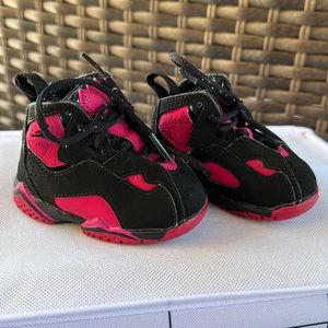 Pink and black Jordan sneaker. Crib shoe.